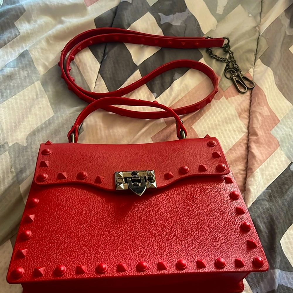I’m selling a red crossbody bag it’s very bulky but it’s very good material.